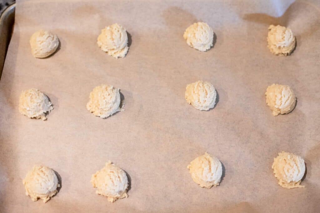 This is a picture of cookie dough balls on a sheet pan.