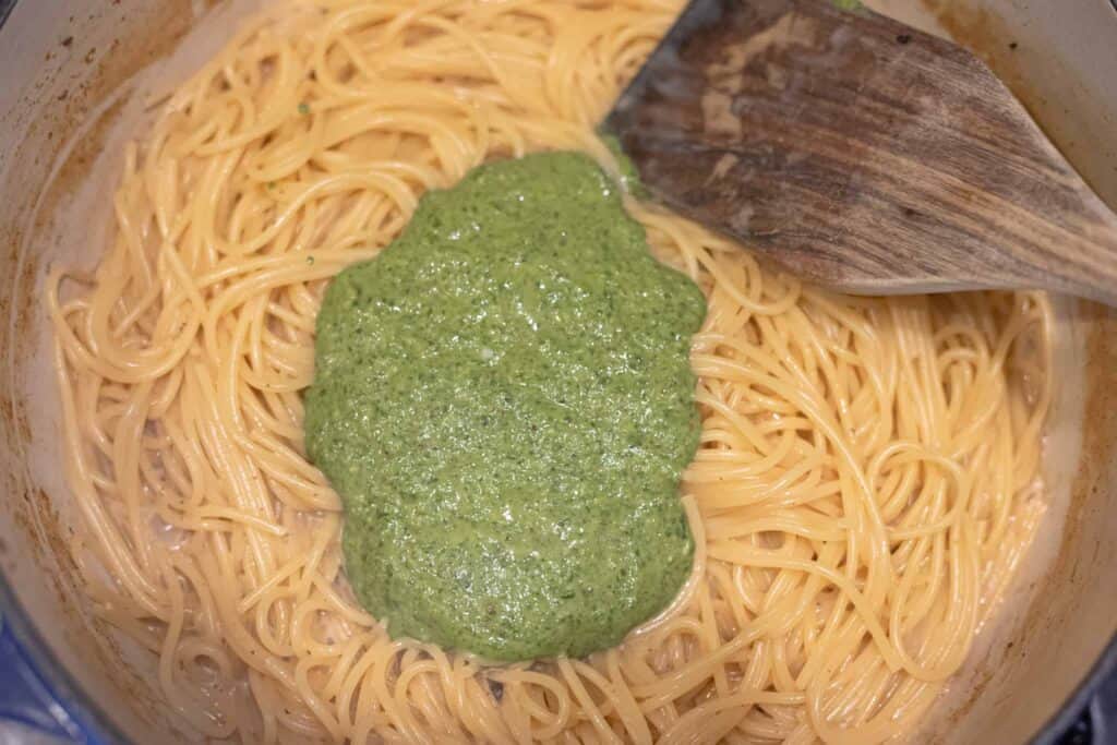 This is a picture of pesto being stirred into spaghetti. The Hangry Economist.