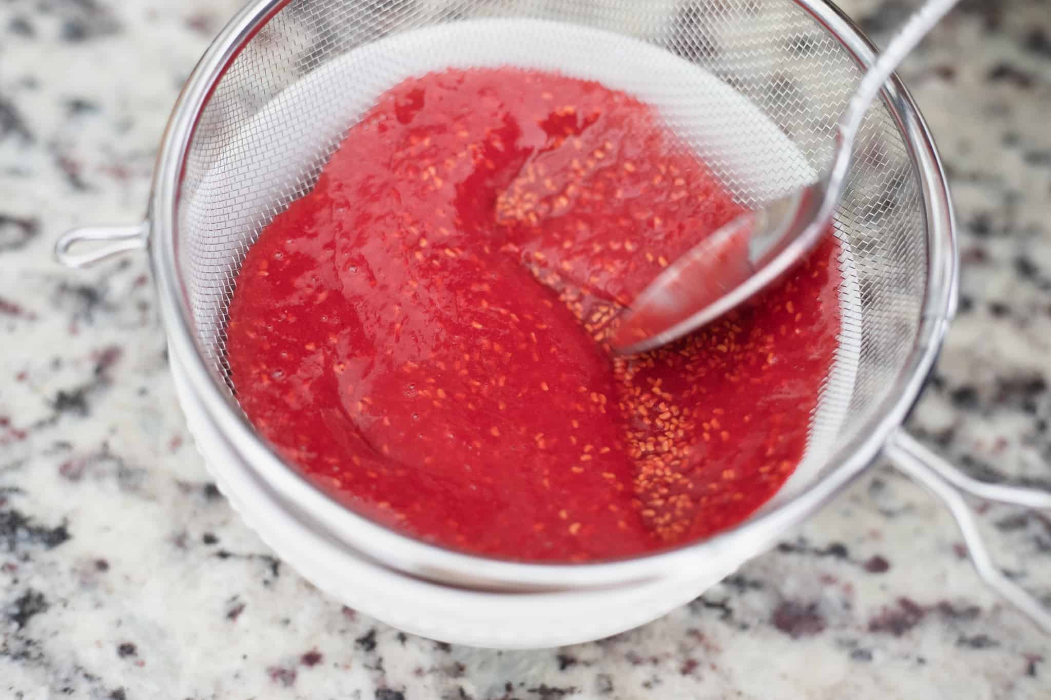This is a picture of raspberries in a fine mesh strainer. The Hangry Economist.