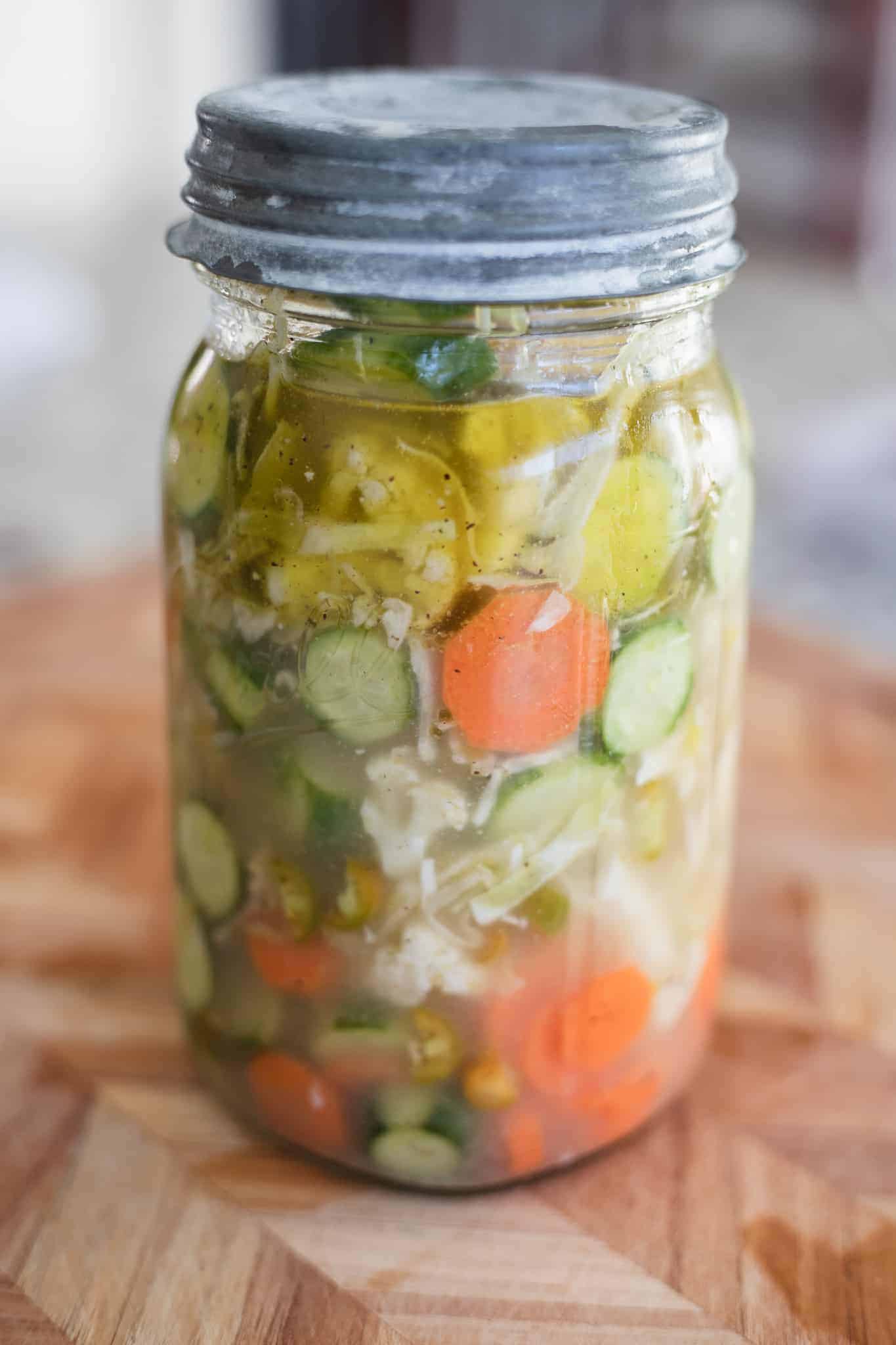 This is a picture of vegetables marinating in a vinegar-based marinade in a jar. The Hangry Economist.
