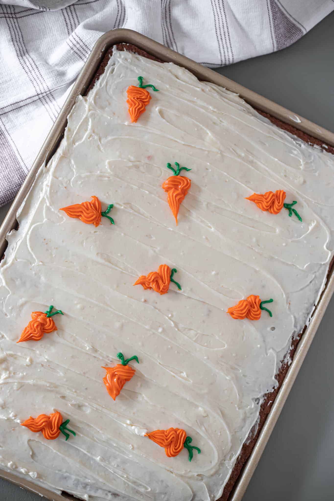 This is a picture of sheet pan carrot cake bars with cream cheese frosting. The Hangry Economist.