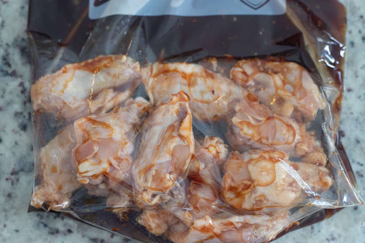 Chicken wings in a gallon baggie of marinade. 