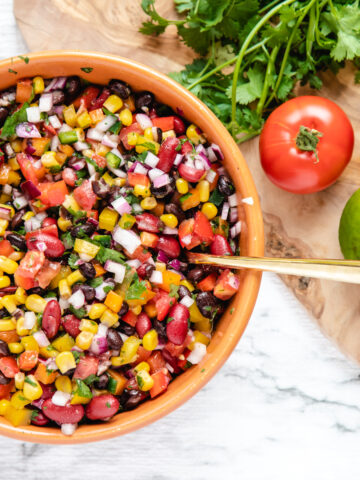 Corn, bean, and vegetable salsa in a large bowl.