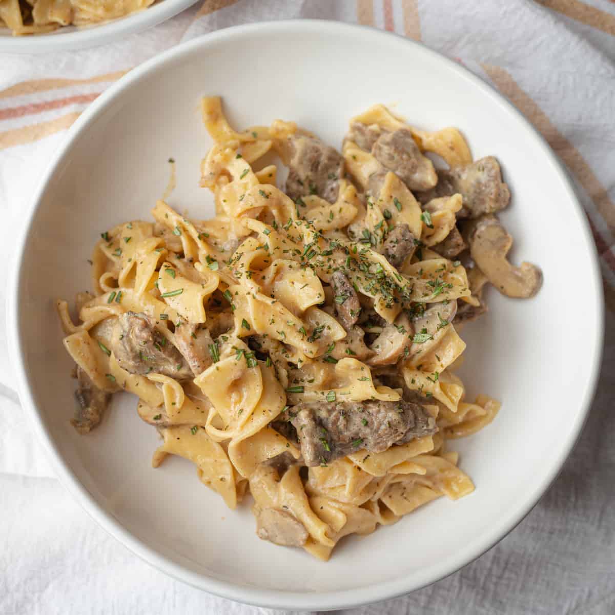 Greek yogurt beef stroganoff in a serving bowl. 