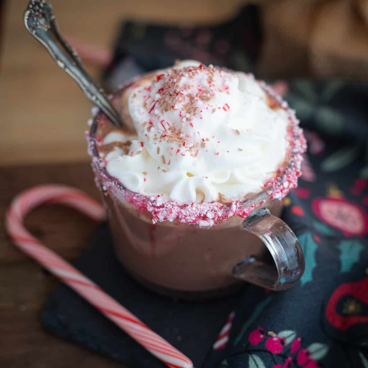 Dairy-free hot chocolate in a mug topped with whipped cream and peppermint. 