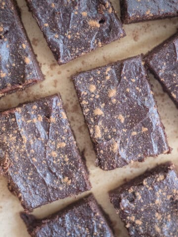 Date brownies on a sheet of parchment paper.