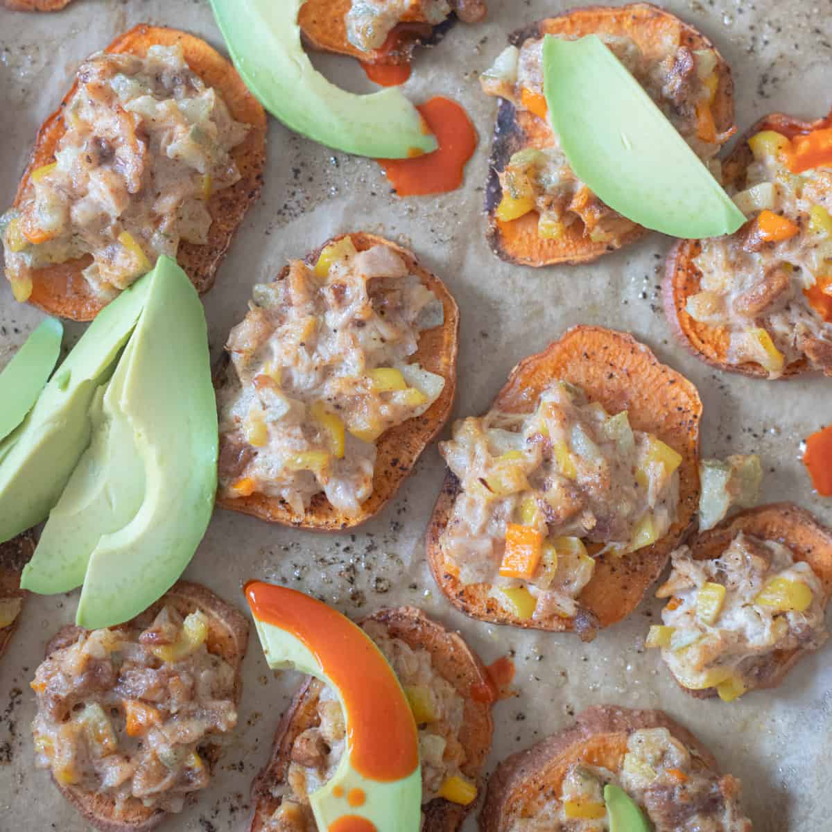 Sweet potato slices topped with a baked tuna mixture, avocado, and hot sauce. 