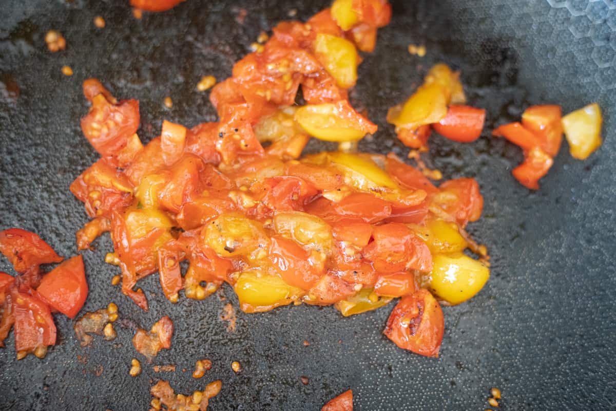 Tomatoes cooking in a pan. 