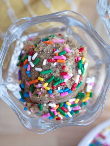 A serving dish of healthy edible sugar cookie dough topped with sprinkles.