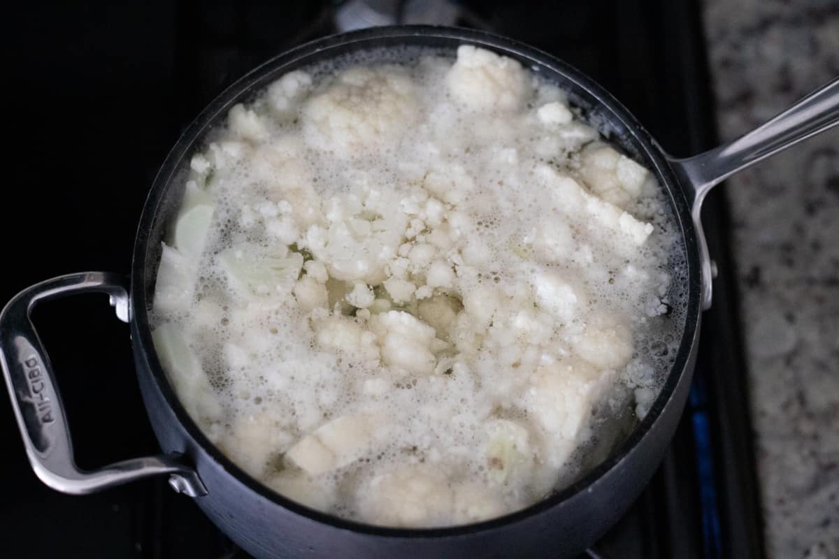 Cauliflower cooking in a pot of boiling water. 