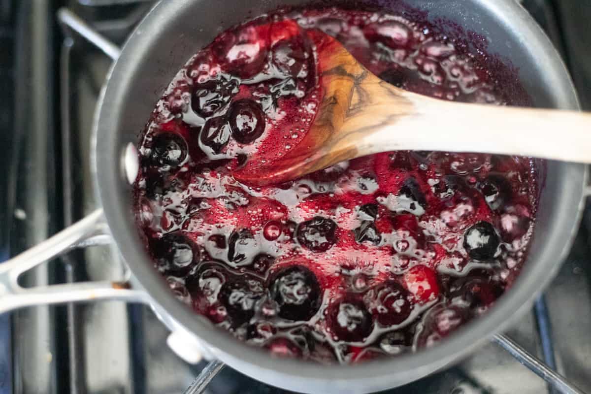 Blueberries cooking in a saucepan. 