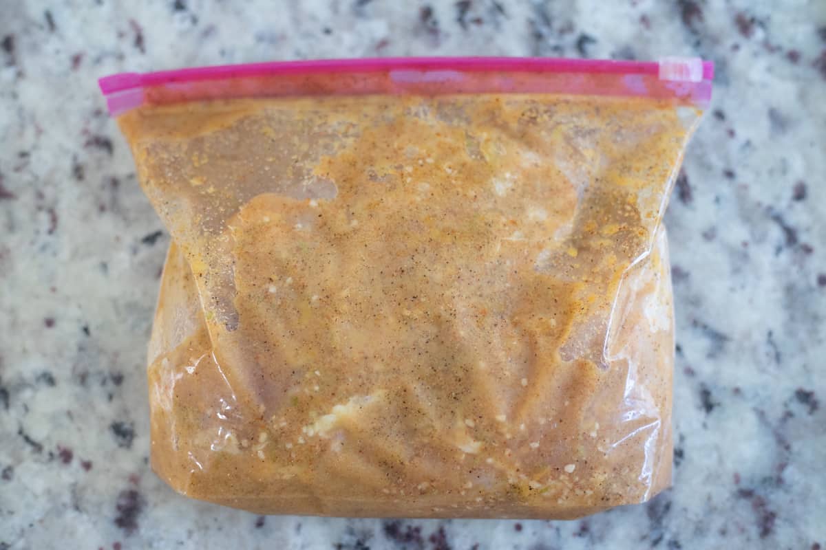 Chicken marinating in a baggie. 