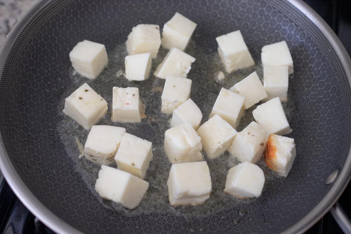 Halloumi cheese frying in a pan. 
