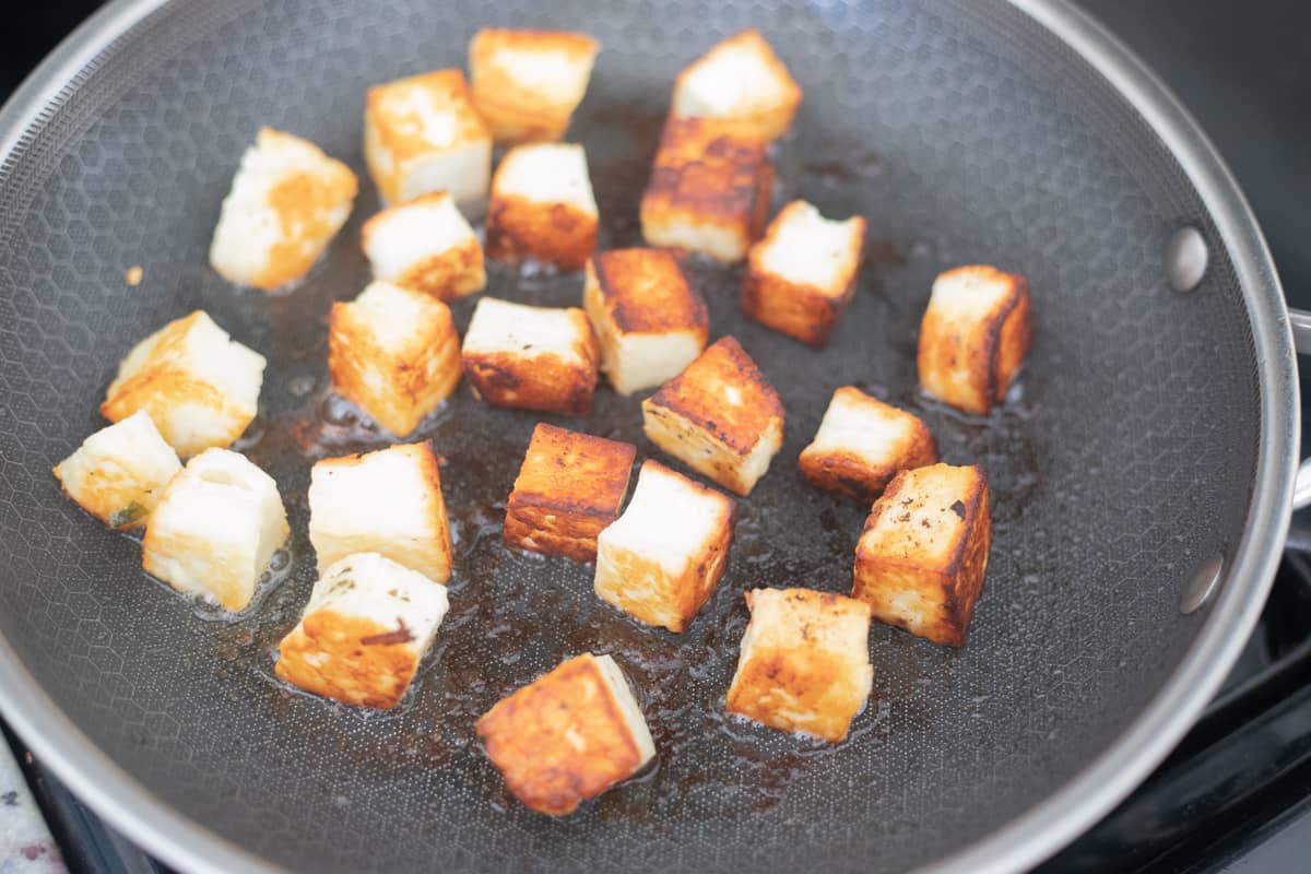 Halloumi cheese that has been browned on one side in a frying pan. 