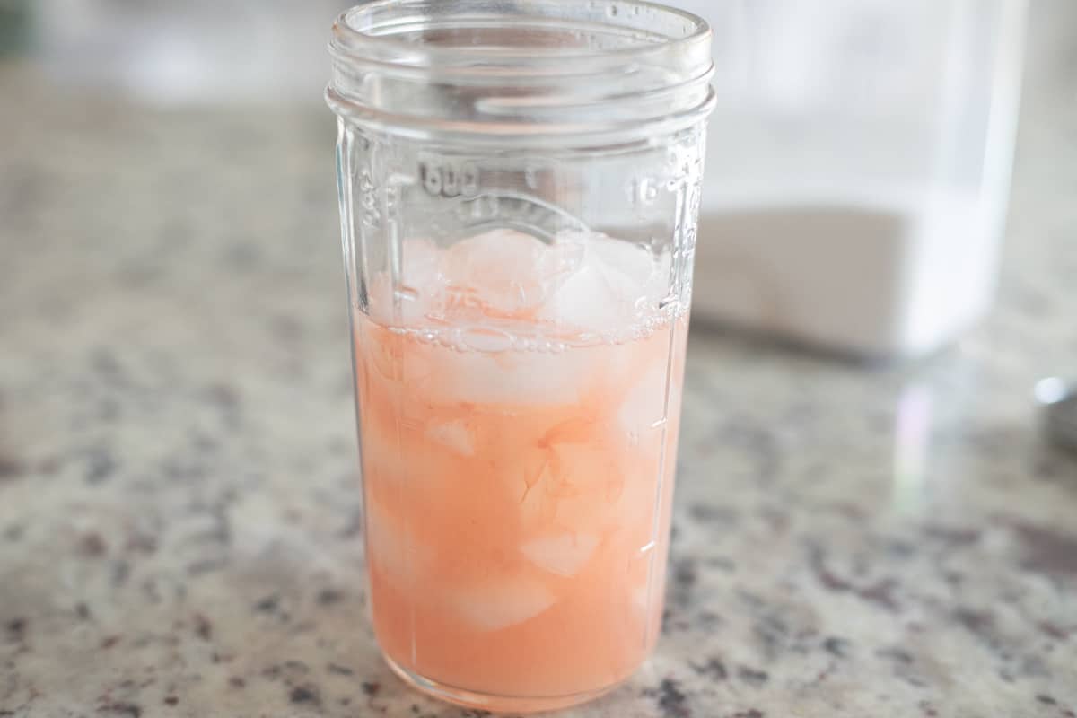 Grapefruit juice in a large jar with ice. 