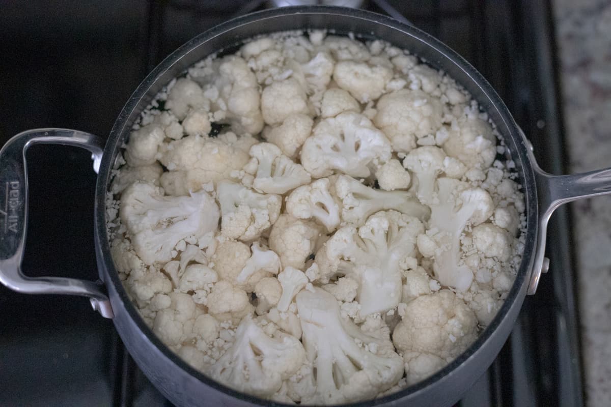 Cooked cauliflower in a pot of water. 