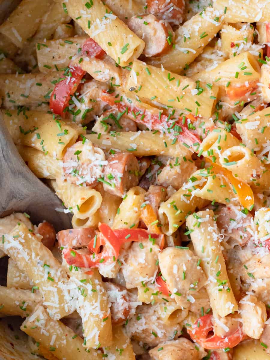 A bowl of one-pot cajun chicken pasta topped with chives. 