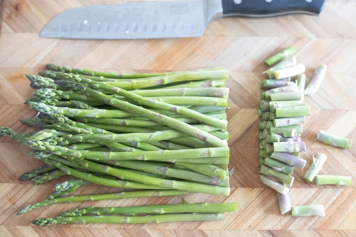 The woody ends of asparagus cut off of a bunch of asparagus spears. 