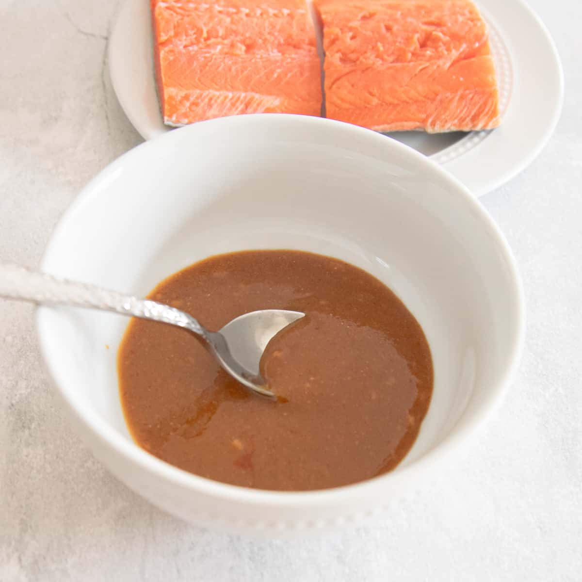 Miso sauce ingredients mixed together in a bowl. It's brown in color and smooth in texture. 