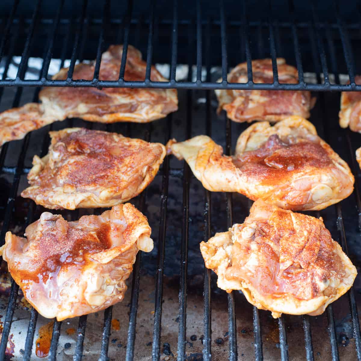 Chicken thighs cooking on a Traeger. 