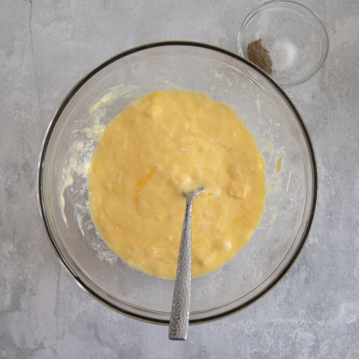 Whisked eggs and greek yogurt in a mixing bowl. 